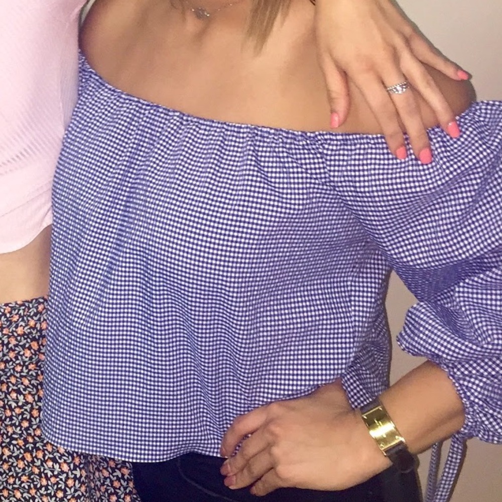 Off the should blue and white checkered top.